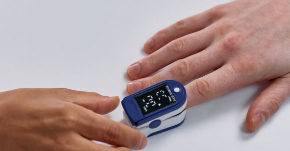Heart Rate Monitoring - Index Finger in Blue Pulse Oximeter